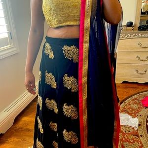 Beautiful velvet embroidered lengha with contrast gold blouse and net duppata